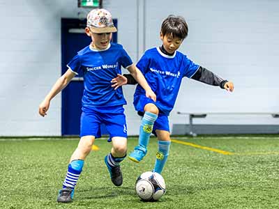 2 kids playing soccer